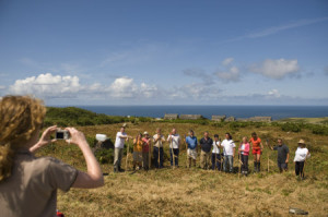 Taking a group photograph of volunteers clearing bracken on a National Trust Working Holiday, at Bosigran Farm, Cornwall