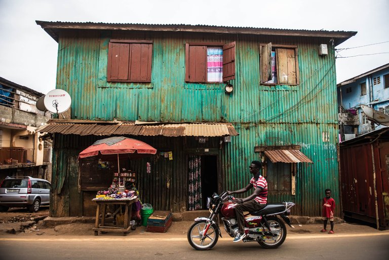 Corrugated zinc sheeting now covers many of the remaining board houses in and near Freetown, Sierra Leone. Preservation efforts are not well funded. © Tommy Trenchard, New York Times 
