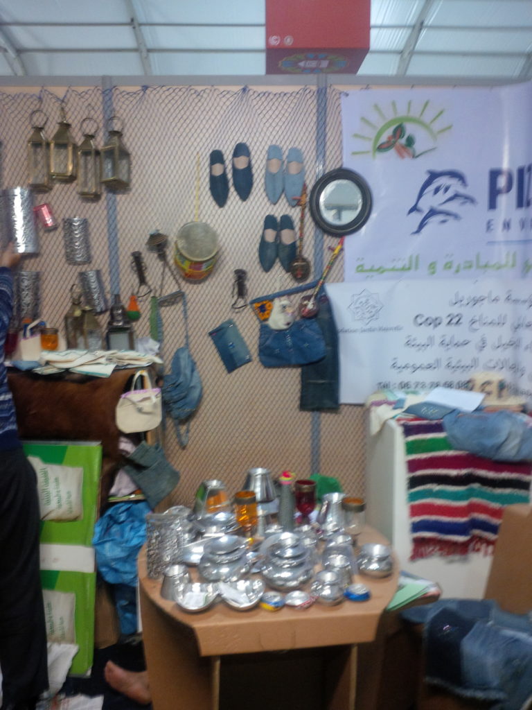 A stall in the green zone selling recydled metal goods and other wares.